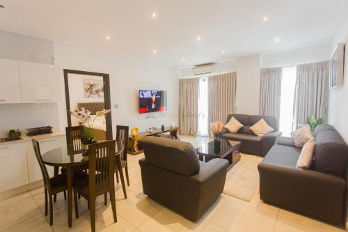 a living room with a couch and a table at Accra Luxury Apartments @ The Signature in Accra