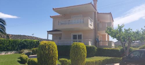 a large house with bushes in front of it at Evelina's studio in Artemida
