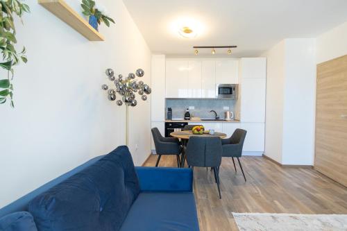 a living room with a blue couch and a table at Azur Pearl by RV Apartments in St. St. Constantine and Helena