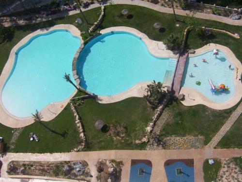 an overhead view of two large swimming pools at Gemelos 22-Fincas Benidorm in Benidorm