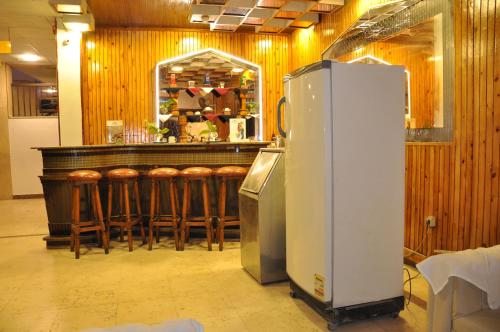 a bar with a refrigerator and some bar stools at Shady Hotel Luxor in Luxor