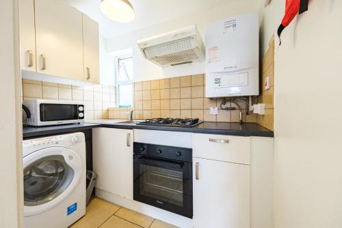 a kitchen with a washing machine and a washer at 33B Steepleview in Trim