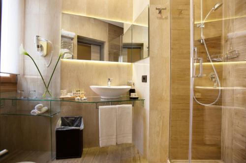a bathroom with a sink and a shower at Hotel Trapani In in Trapani