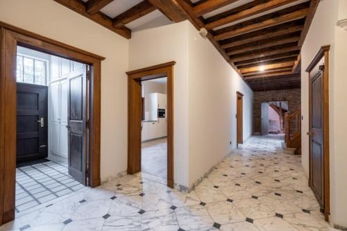 an empty hallway with a door and a tile floor at Luxury Villa Schaffen with a private gym in Diest