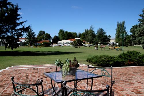 a table and chairs on a brick patio at La Campiña Club Hotel & Spa in Santa Rosa