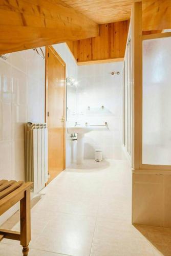 a bathroom with a sink and a toilet in a room at Olympia by Cardi Suites in Formigal