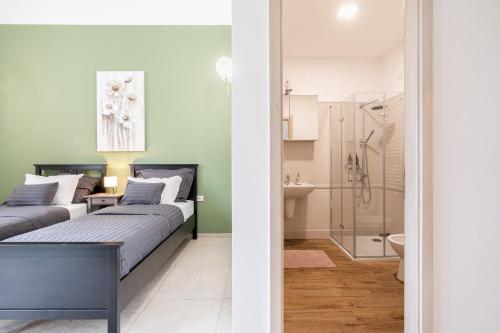 a bedroom with two beds and a bathroom at Amora Homes Basilica Monnalisa luxury 3 bedrooms apartment with amazing view NEED RESERVATION X FREE PARKING in Budapest
