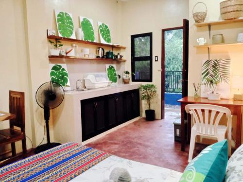 a living room with a bed and a sink and a desk at Amwani Azure in Puerto Princesa City
