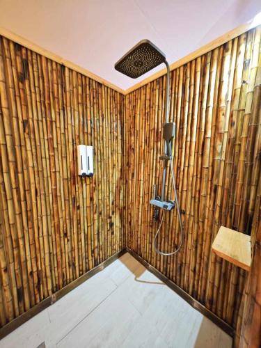 a bathroom with bamboo walls and a shower at Longoza Ecolodge in Andasibe