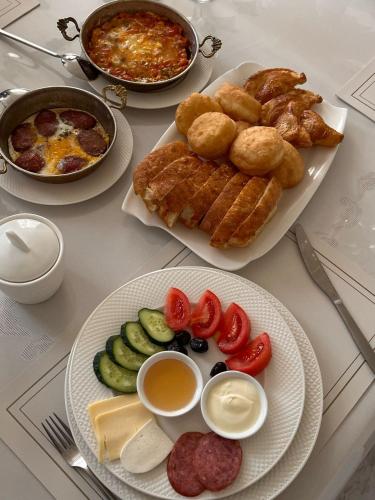 a table with two plates of food on it at Yassy hotel, Turkistan in Türkistan