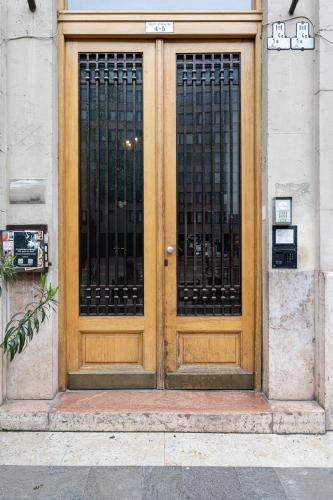a wooden door with black gate on a building at Amora Homes Basilica Monnalisa luxury 3 bedrooms apartment with amazing view NEED RESERVATION X FREE PARKING in Budapest