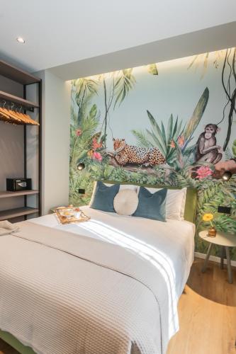 a bedroom with a large white bed with a mural at Rezia Apartments by Rent All Como in Como