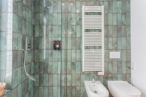 a bathroom with a shower with a toilet and a sink at Rezia Apartments by Rent All Como in Como