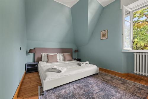 a bedroom with a bed and a window at Ruby Como Villa with Lake View By Petra Luxury in Laglio