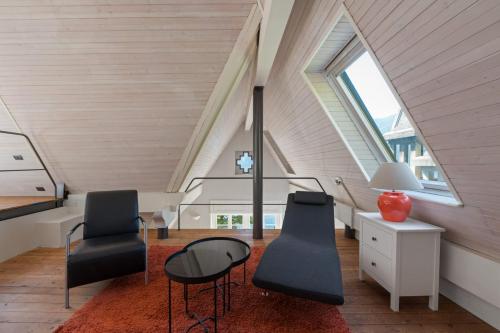 a room with two chairs and a table and a staircase at Ruby Como Villa with Lake View By Petra Luxury in Laglio