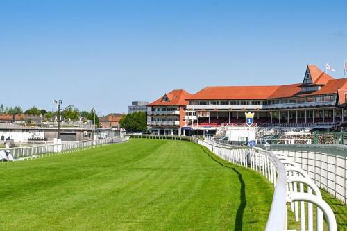 a stadium with white fences and a green field at Central Chester Apartment, 2 beds, 3 guests in Chester