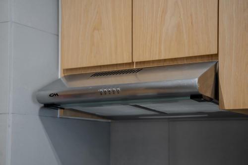 a stainless steel stove hood in a kitchen at 1Bedroom & Living room Apartment - The Sahara Suite in Sharjah Intl