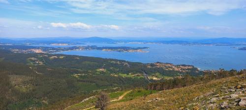 a view of a large body of water on a hill at Playas salvajes y relax in Ribeira