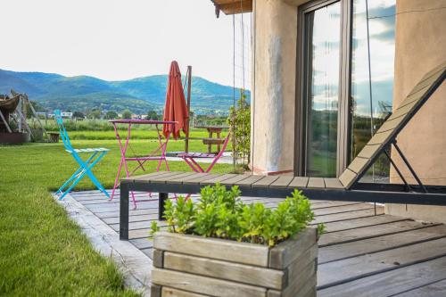 a patio with chairs and a table and chairs at Parenthèse Elément Terre in Wattwiller