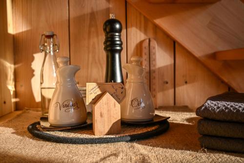 a table with two bottles and a wooden box at Parenthèse Elément Terre in Wattwiller