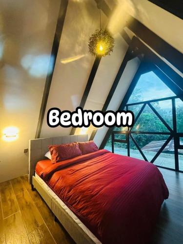a bed in a room with a large window at Sariaya Staycation-Pool, Jacuzzi, PS5 and WiFi in Sariaya