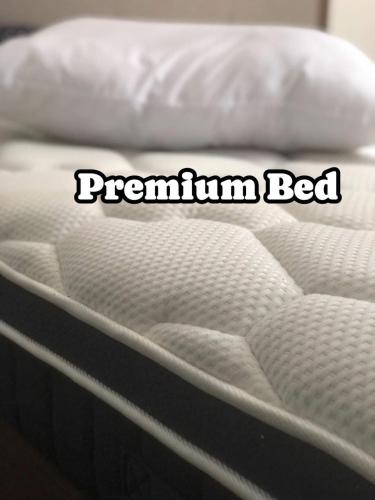 a close up of a mattress with the words premium bed at Sariaya Staycation-Pool, Jacuzzi, PS5 and WiFi in Sariaya