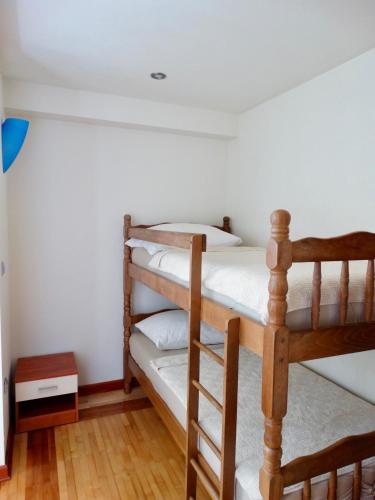 two bunk beds in a room with wooden floors at Apartmani Maris in Neum
