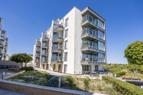 an apartment building with balconies and trees at Sea Breeze - Close to Bournemouth Beach and Seafront in Bournemouth