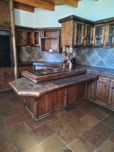 a kitchen with a stove top in a room at Vryburg Good Time Yafe Guest House in Vosburg