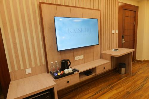 a living room with a flat screen tv on a wall at Hotel Mantavya in Kakarmatha