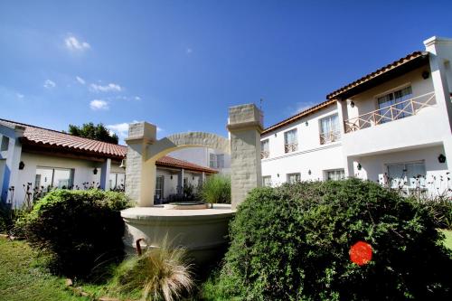 a large white building with a fountain in the yard at La Campiña Club Hotel & Spa in Santa Rosa