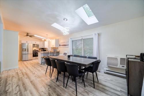 a kitchen and dining room with a table and chairs at Catskills Lakefront with Hot Tub, Sauna and Theater in Monticello