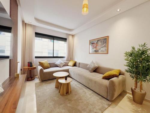 a living room with a couch and a table at Cosy Central Appart in Casablanca Best Location in Maarif