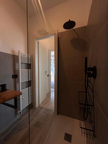 a bathroom with a shower and a glass door at AMoR in Salò