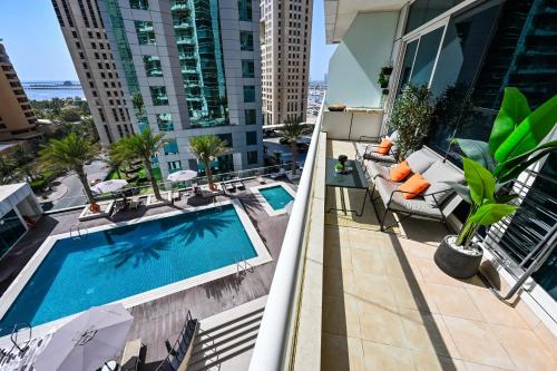 a balcony with a swimming pool on a building at New Renovated Modern 1 Br Dubai Marina in Dubai