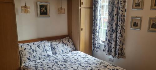 a small bedroom with a bed and a window at 223 Websters land - stunning castle view in Edinburgh
