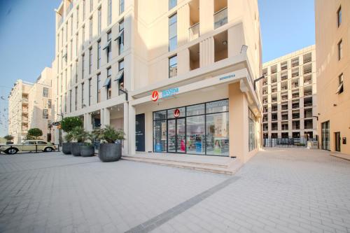 an empty street in a city with a store at 1BR Mamsha Nest with balcony by BlueCloud Holidays in Sharjah Intl
