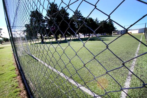 a chain link fence with a soccer field behind it at La Campiña Club Hotel & Spa in Santa Rosa
