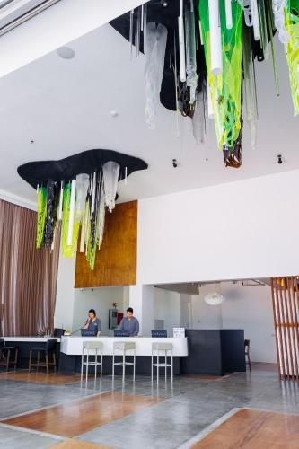 two men sitting at a desk in a room at Canvas Boutique Hotel in Puerto Princesa City