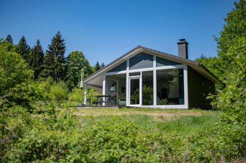 a small house with a large glass door at 2 Personen mit Sauna F3H5 in Ruhla