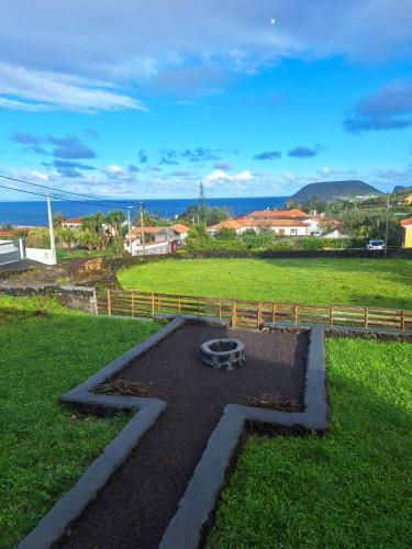 a garden with a fire pit in the grass at Quinta do Almanac in Queimada