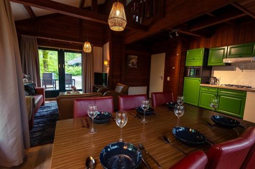 a dining room with a table with wine glasses on it at Vacation Home North Limburg in Blitterswijck