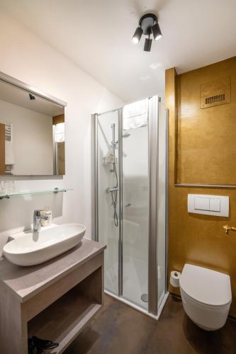 a bathroom with a sink and a shower at Johannes Schlössl - Gästehaus der Pallottiner am Mönchsberg in Salzburg