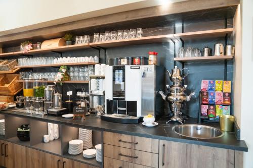 a kitchen with a counter with a coffee maker at Johannes Schlössl - Gästehaus der Pallottiner am Mönchsberg in Salzburg