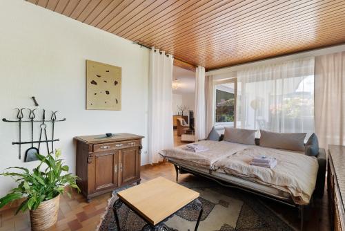 a bedroom with a bed and a wooden ceiling at Ferien Am Weinberg in Kappelrodeck