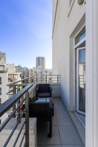 a balcony with a bench and a view of a city at Magnificent Diamond Duplex in Tbilisi City