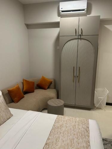 a bedroom with a bed and a couch and a tv at Colombo, Trizen Luxury Apartments, Sri Lanka in Colombo