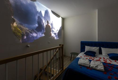 a bedroom with a bed and a mural on the wall at Magnificent Diamond Duplex in Tbilisi City
