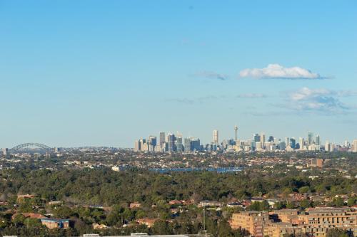 a view of the city with auckland in the background at Modern Apartment with City View at Sydney Olympic Park in Sydney