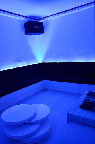 a blue room with a table and a tv on top at Thunderbird Resorts - Rizal in Binangonan